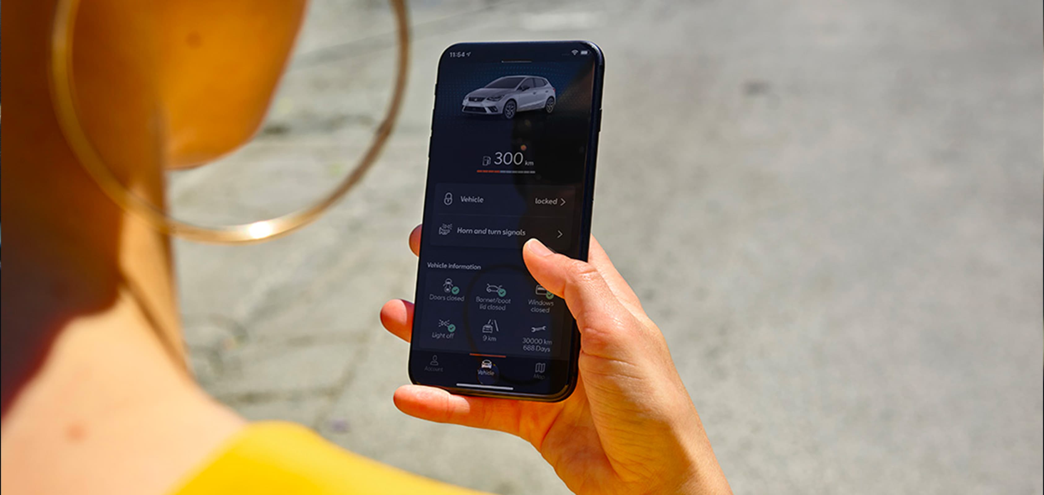 Woman looking at herself on her smartphone connect to SEAT CONNECT