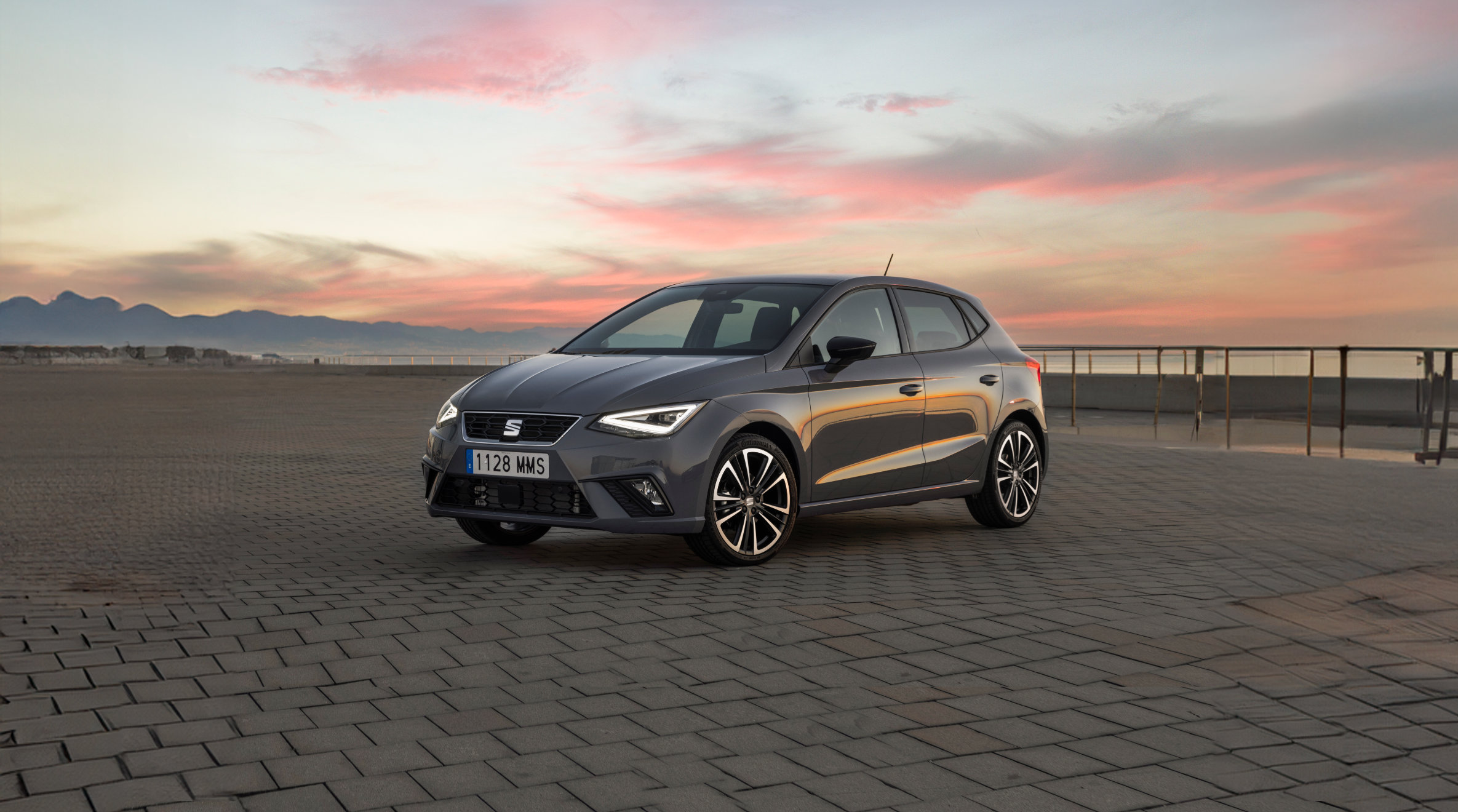 Man, jumping behind SEAT Ibiza desire red colour FR trim