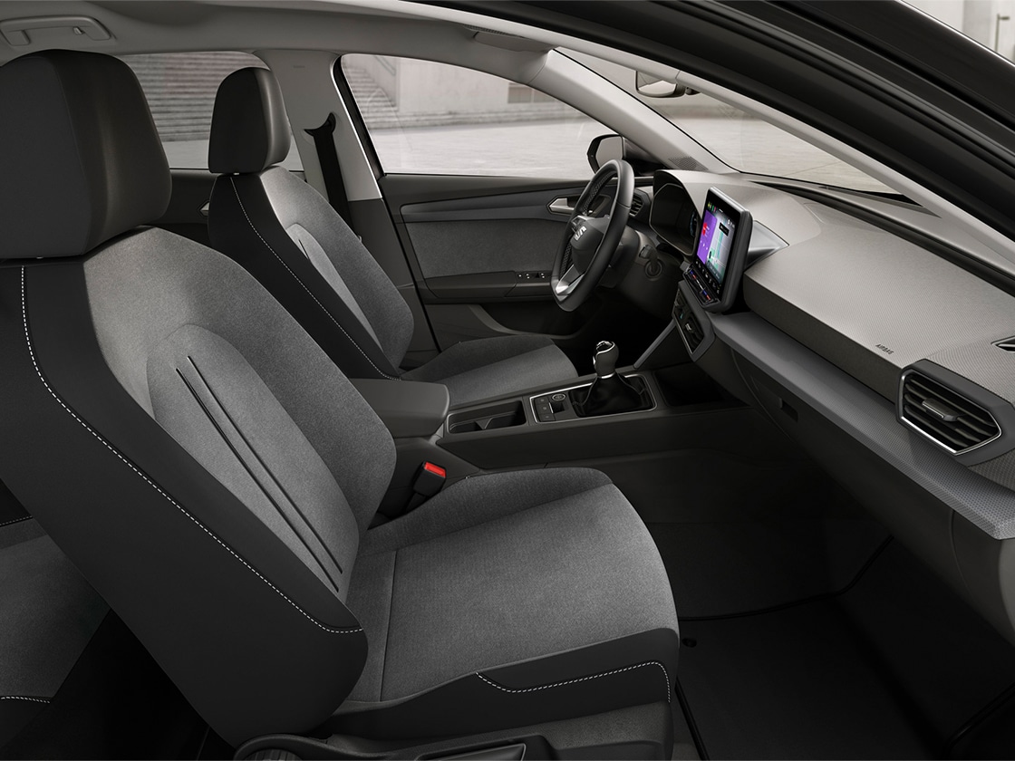 Vista degli interni della SEAT Leon con sedili Comfort con rivestimento di stoffa, che offrono un'esperienza di guida rilassata e funzionale.