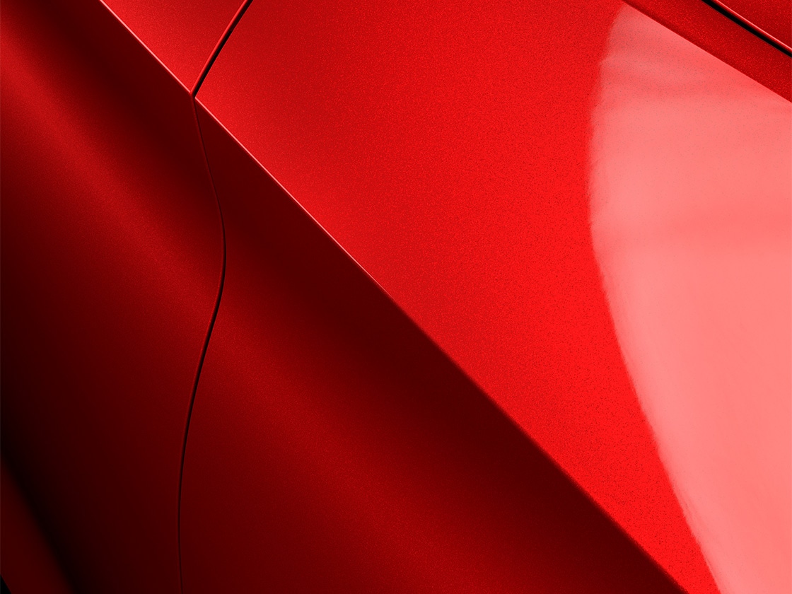 Seat Leon in Rosso Intenso con una speciale finitura metallizzata, in primo piano.