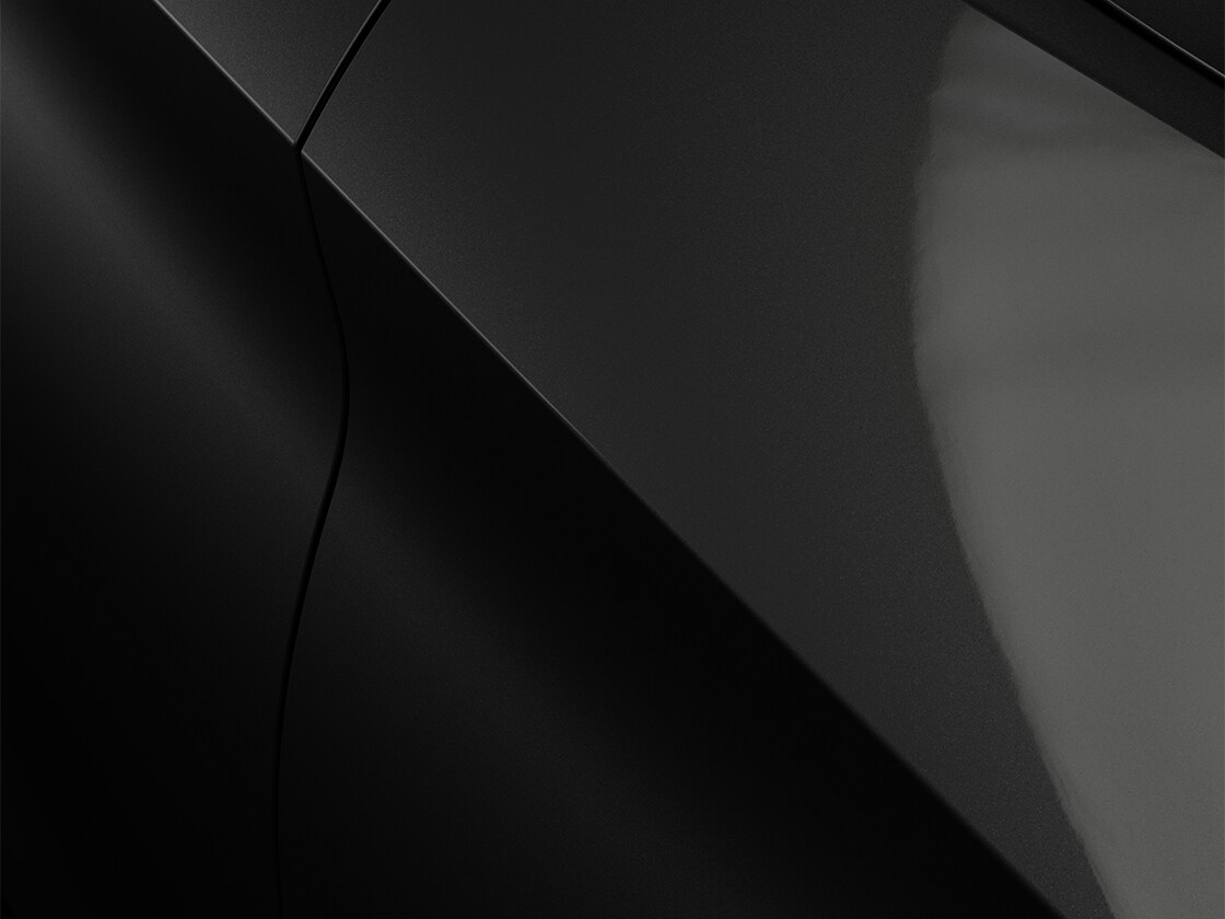 The leon estate car, seat leon sportstourer, in midnight black with a metallic finish, close up.