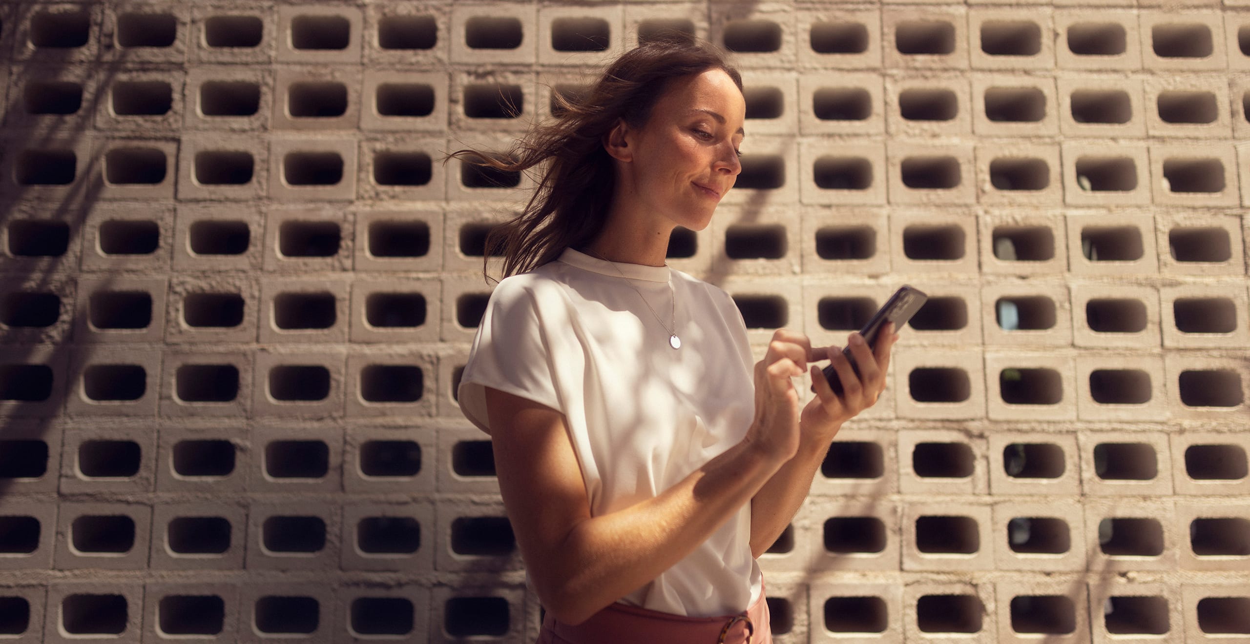 Donna con il suo smartphone connesso a  SEAT CONNECT